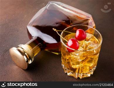 high angle whiskey glass cherries with bottle