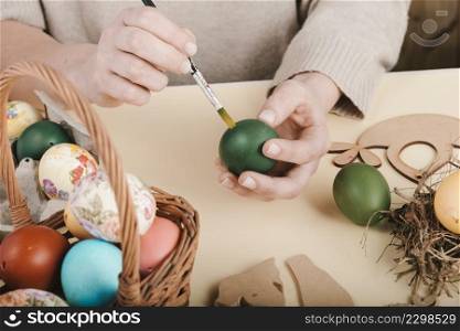 high angle woman decorating easter eggs