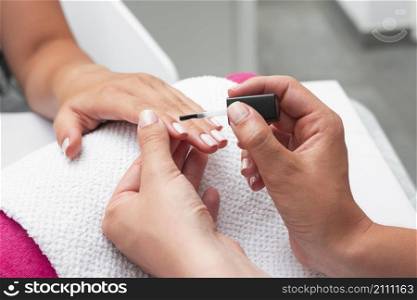 high angle woman doing manicure client