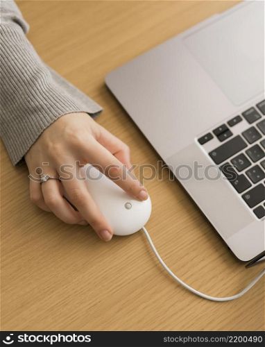 high angle woman laptop using mouse