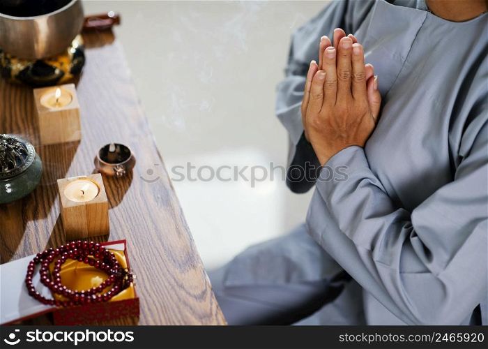 high angle woman praying front candles
