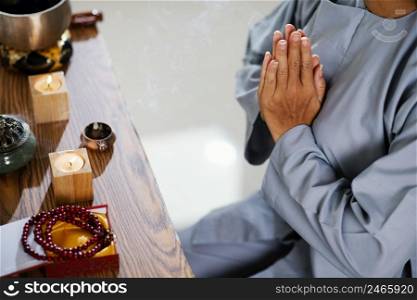 high angle woman praying front candles