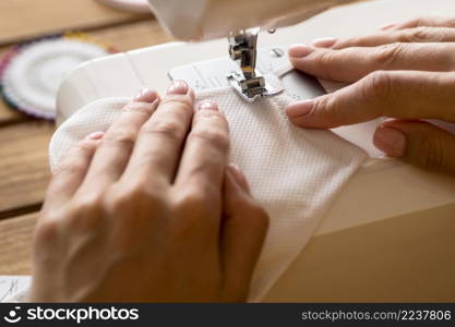 high angle woman using sewing machine face mask