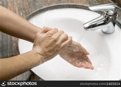 high angle woman washing hands