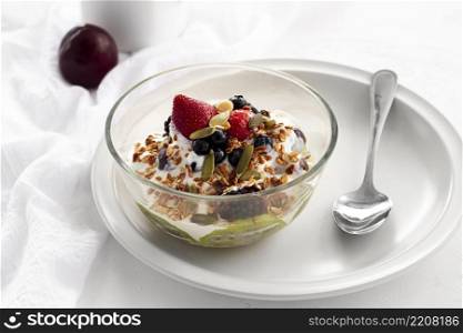 high angle yogurt with cereals fruits