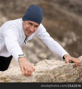 high angle young man climbing rocks nature