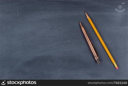 High angled view of blackboard with pen and pencil.