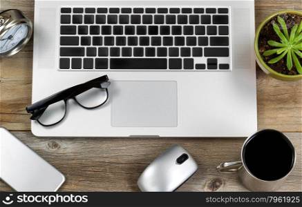 High angled view of desktop with mobile technology and a cup of coffee. Layout in horizontal format.