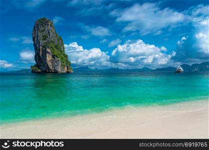 high cliff in the sea and a yacht in the sea near the island of Poda, Thailand