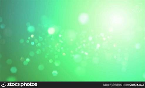High definition animated background loop of a soft green sunny, particle sky.