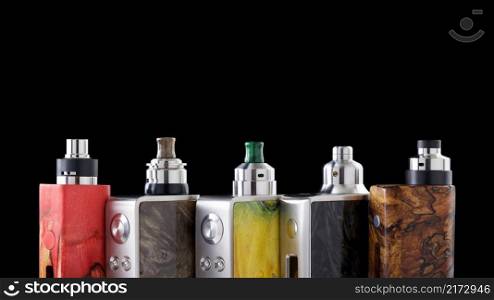 high end rebuildable dripping atomizers for flavour chaser on regulated stabilized wood box mods isolated on black background, vaping device, hd ratio, 16x9