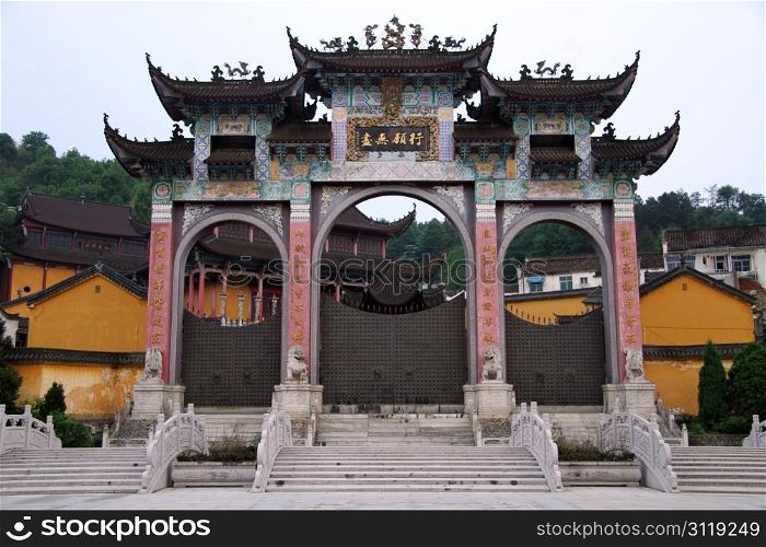 High gate of temple and marble bridge in Jiuhua Shan village, China