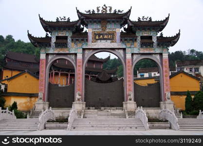 High gate of temple and marble bridge in Jiuhua Shan village, China