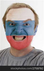 High key portrait of an angry man whose face is painted in colors of russia flag