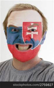 High key portrait of an angry man whose face is painted in colors of slovakia flag