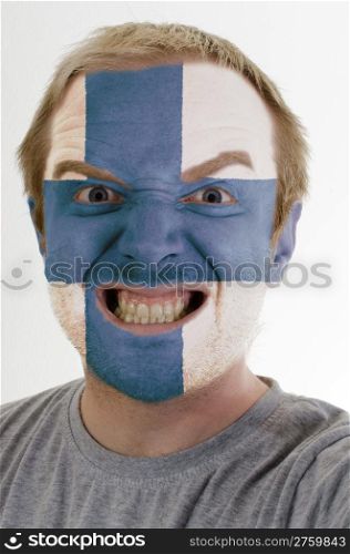 High key portrait of an angry man whose face is painted in colors of finland flag