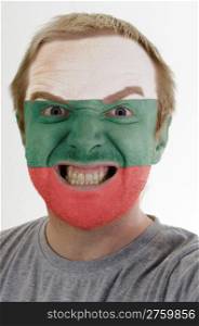 High key portrait of an angry man whose face is painted in colors of bulgaria flag
