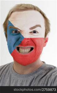 High key portrait of an angry man whose face is painted in colors of czech flag