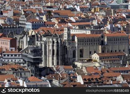 High level view over the rooftops the Bairro Alto and Estrela district of the city of Lisbon, Portugal. Central is the ruins of Igreja do Carmo and the Elevator de Santa Justa.