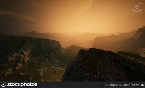 High mountain peaks covered with dramatic heavy fog. Misty mountains in a sunset light.. High mountain peaks covered with dramatic heavy fog
