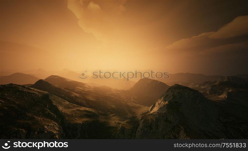 High mountain peaks covered with dramatic heavy fog. Misty mountains in a sunset light.. High mountain peaks covered with dramatic heavy fog