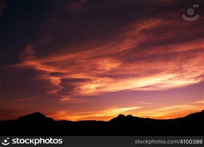 high mountain silhouette with beautiful colorful clouds.
