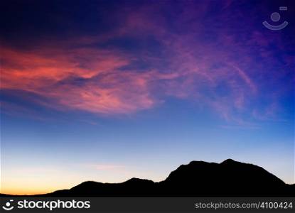 high mountain silhouette with beautiful colorful clouds.