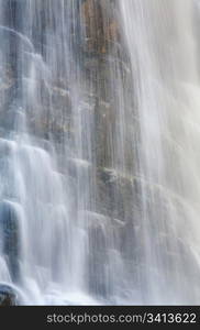 High mountain waterfall in dark wild Carpathian forest