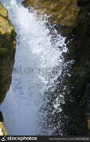 High mountain waterfall in dark wild Carpathian forest