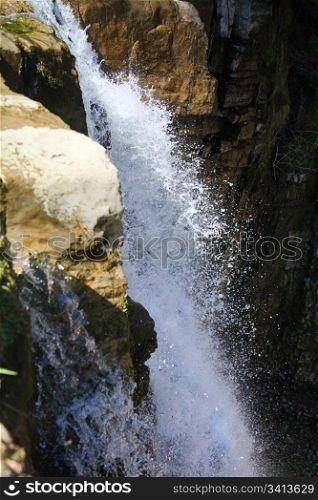 High mountain waterfall in dark wild Carpathian forest