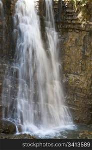 High mountain waterfall in dark wild Carpathian forest (long exposure shooting)