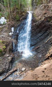 High mountain waterfall in wild Carpathian forest (Guk Waterfall, Ivano-Frankivsk Region, Ukraine).