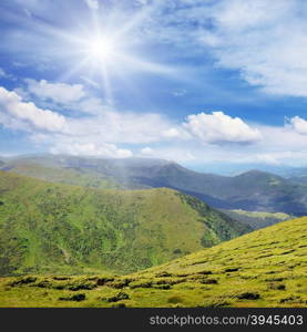 High mountains and sun on blue sky