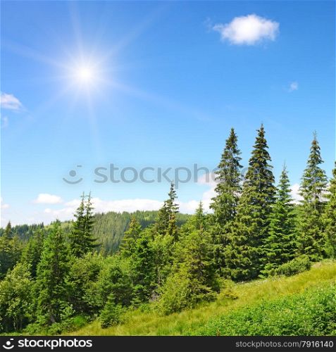 High mountains and sun on blue sky