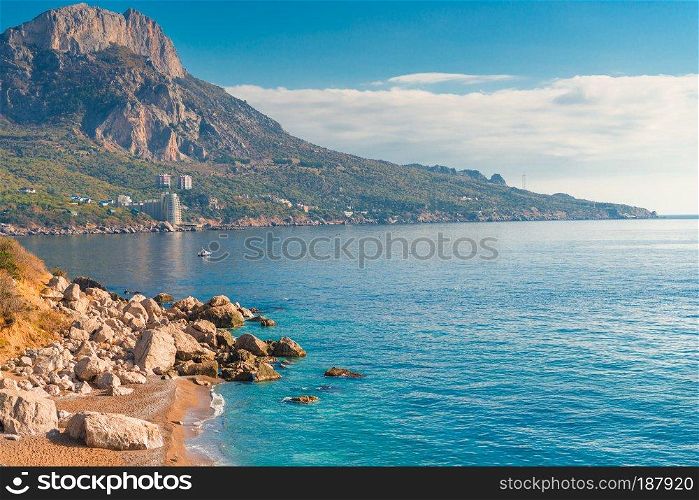 High mountains, rocks and blue calm sea on a sunny day