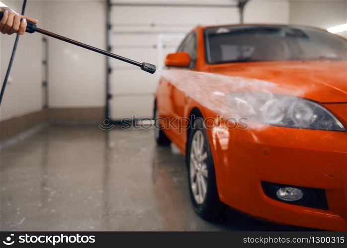 High pressure water on the car, wash service. Vehicle cleaning, carwash station, car-wash business. High pressure water on the car