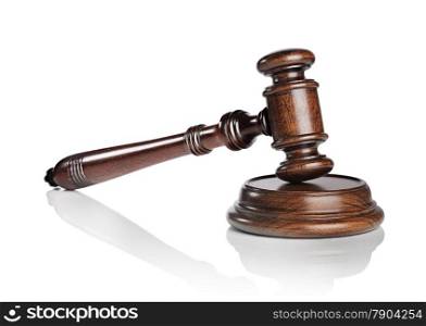 High quality mahogany wooden gavel with a sound block isolated on white with natural reflection.