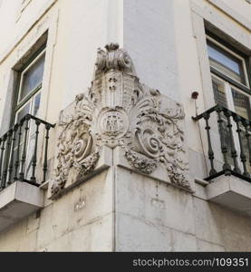 High relief decoration on a building corner in downtown Lisbon, Portugal