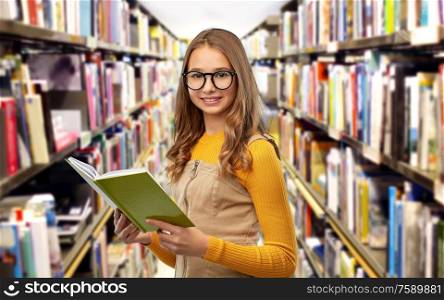 high school, education and knowledge concept - smiling teenage student girl in glasses reading book over grey background. student girl in glasses reading book at library