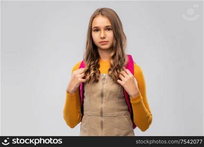 high school, education and people concept - smiling teenage student girl with backpack over grey background. smiling teenage student girl with backpack