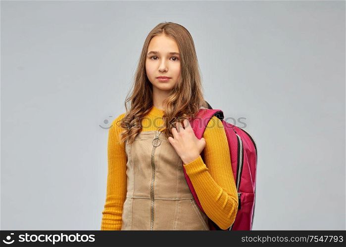 high school, education and people concept - teenage student girl with backpack over grey background. teenage student girl with backpack