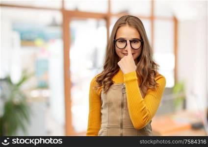 high school, education and vision concept - smiling teenage student girl in glasses over classroom background. smiling teenage student girl in glasses at school