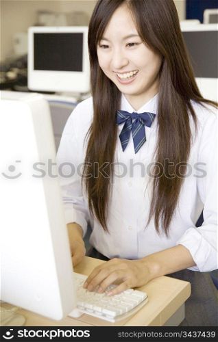 High school girl operating a PC