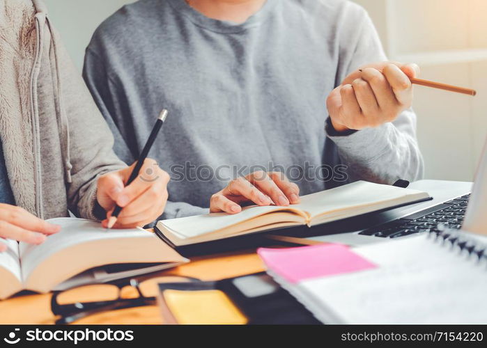 High school or college students studying and reading together in library