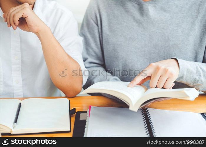 High school or college students studying and reading together in library