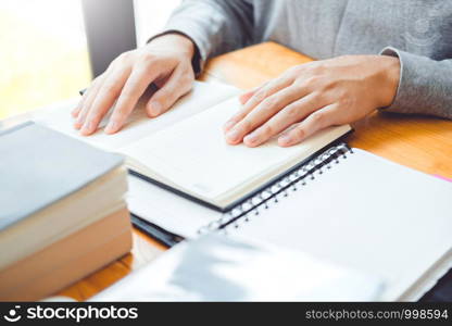 High school or college students studying and reading together in library