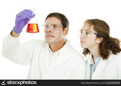 High school student and her teacher examining a chemical compound in the laboratory.