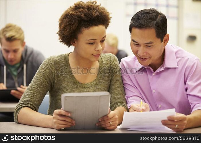 High School Student And Teacher Using Digital Tablet