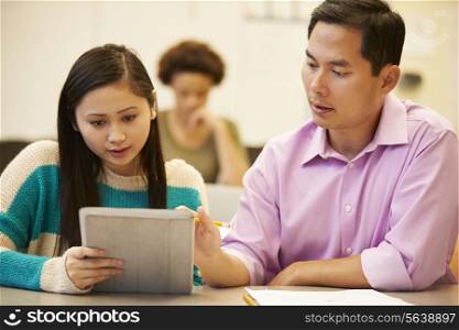 High School Student And Teacher Using Digital Tablet