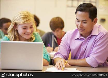 High School Student With Teacher In Class Using Laptop